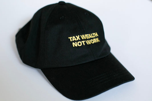 Black cap with 'TAX WEALTH NOT WORK' text in gold on a white background